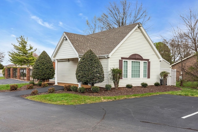 view of home's exterior with roof with shingles