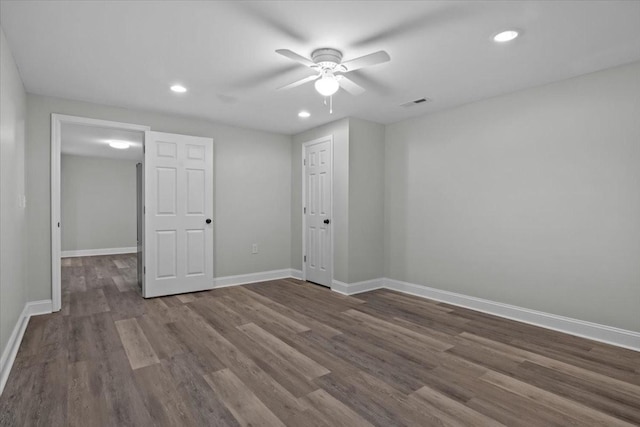 empty room with visible vents, baseboards, ceiling fan, wood finished floors, and recessed lighting