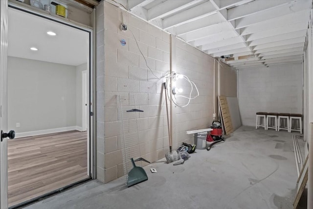 below grade area with concrete block wall and recessed lighting