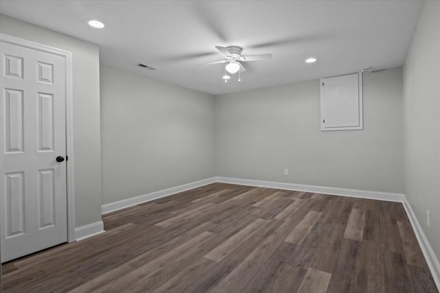 unfurnished room with ceiling fan, wood finished floors, visible vents, and baseboards