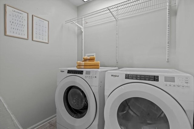 laundry area featuring washer and dryer, laundry area, and baseboards