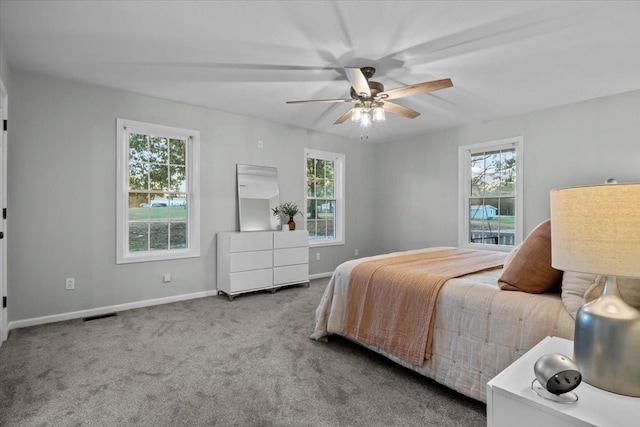 bedroom featuring multiple windows, carpet flooring, visible vents, and baseboards