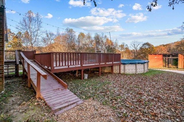 wooden terrace with a covered pool