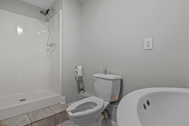 full bath featuring tile patterned floors, toilet, and walk in shower