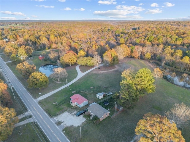 bird's eye view with a forest view and a water view