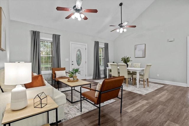 living room with ceiling fan, high vaulted ceiling, dark wood-style flooring, and baseboards