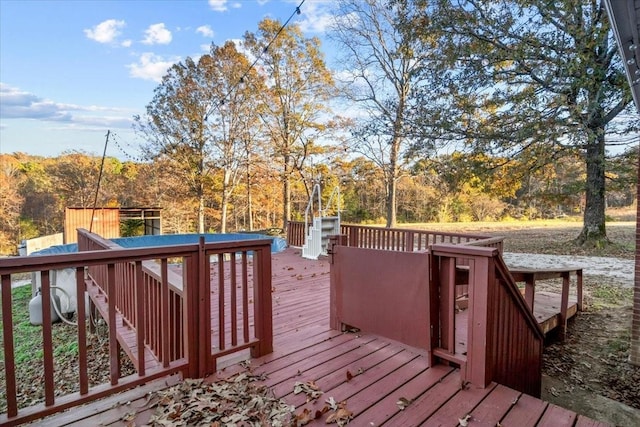 wooden terrace featuring a view of trees