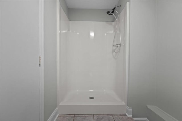 bathroom with baseboards and walk in shower