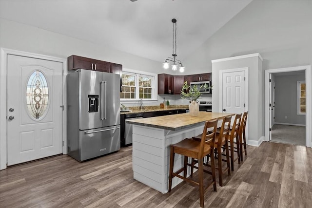 kitchen featuring dark brown cabinets, appliances with stainless steel finishes, and wood finished floors