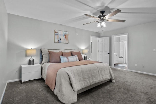 bedroom with ceiling fan, dark carpet, baseboards, and ensuite bathroom