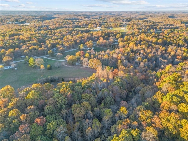 birds eye view of property with a view of trees