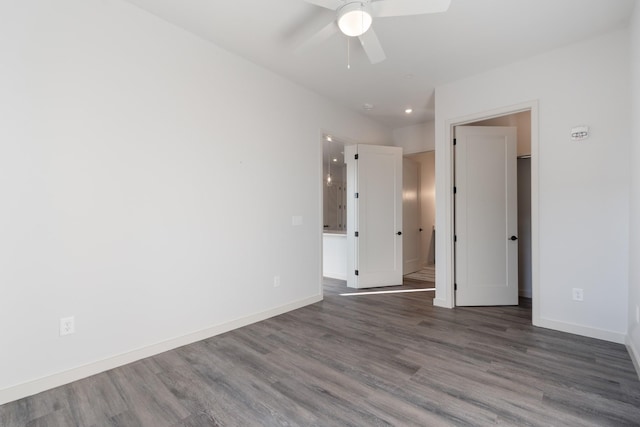 unfurnished room featuring a ceiling fan, baseboards, and wood finished floors