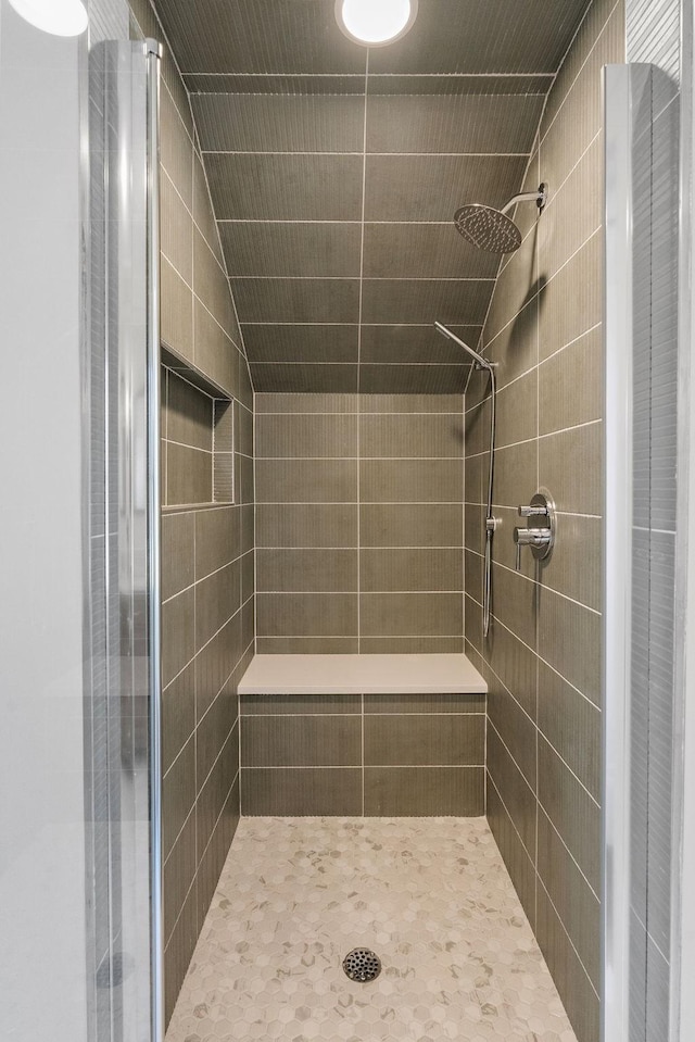 full bathroom featuring lofted ceiling and a stall shower