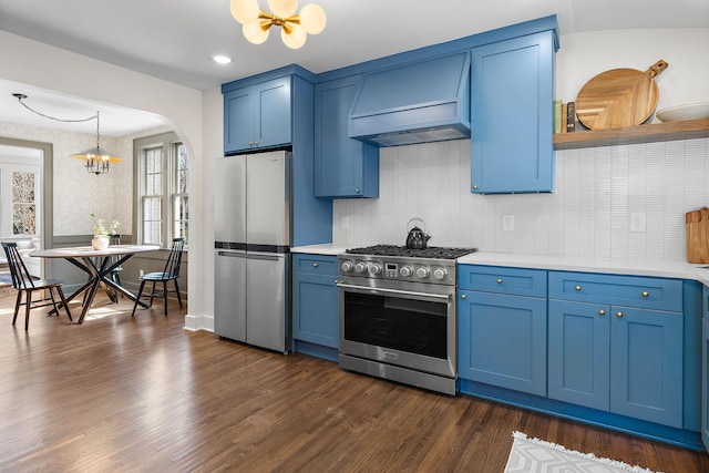 kitchen with blue cabinetry, a chandelier, stainless steel appliances, and light countertops