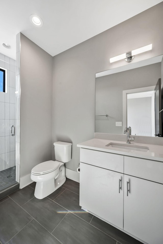 full bath featuring baseboards, toilet, tile patterned floors, vanity, and a shower stall