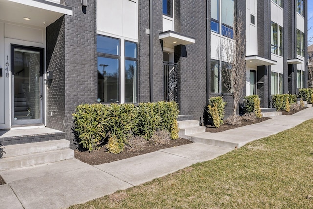 property entrance featuring brick siding