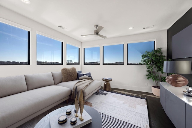 living room with dark wood-type flooring, recessed lighting, and visible vents