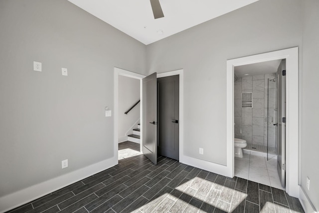 unfurnished bedroom with ensuite bathroom, ceiling fan, wood tiled floor, and baseboards