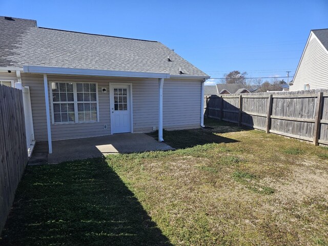 view of yard featuring a patio area and a fenced backyard