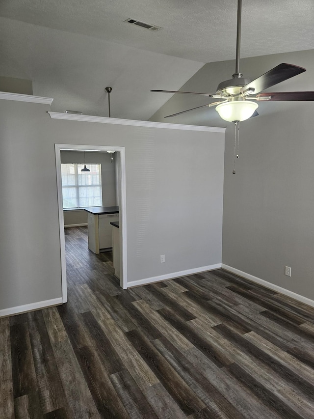 unfurnished room featuring a textured ceiling, dark wood-type flooring, visible vents, baseboards, and vaulted ceiling