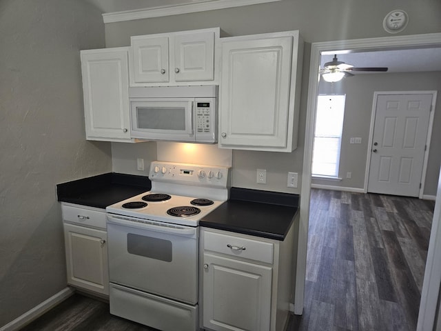 kitchen featuring white appliances, dark wood-type flooring, dark countertops, and white cabinets