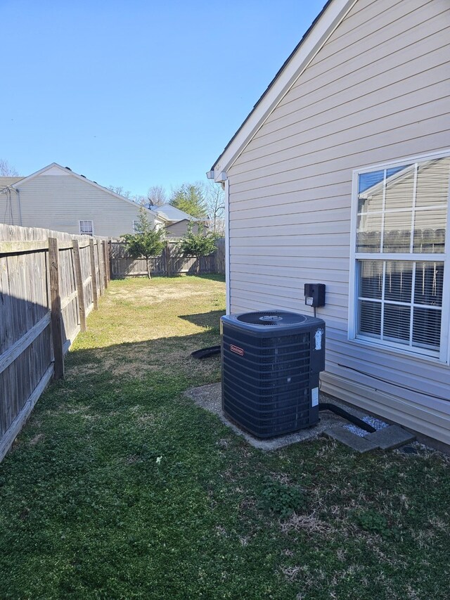 view of yard with cooling unit and a fenced backyard