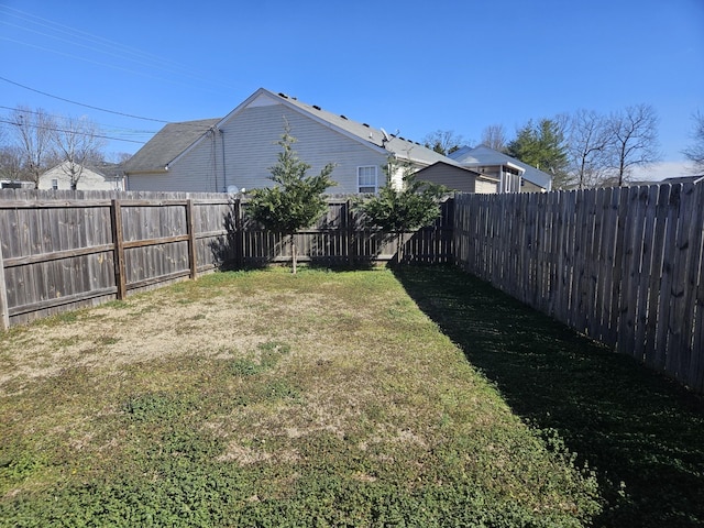 view of yard with a fenced backyard