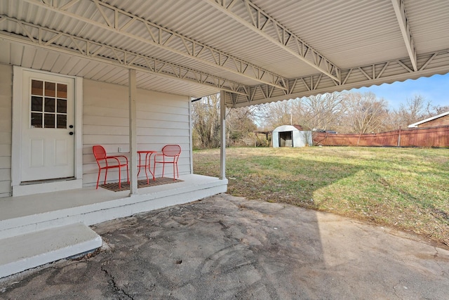 view of patio featuring an outbuilding and fence