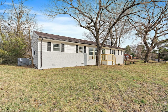 single story home featuring brick siding, crawl space, central AC unit, and a front lawn