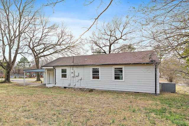 back of house featuring crawl space, cooling unit, and a lawn