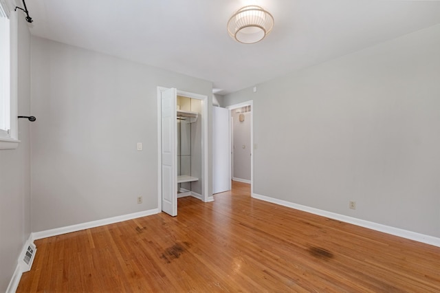 unfurnished bedroom featuring light wood-type flooring, visible vents, and baseboards