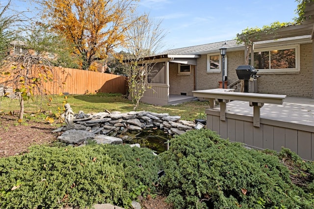 view of yard featuring fence and a wooden deck