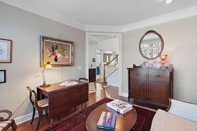 interior space featuring baseboards, crown molding, ornate columns, and stairs