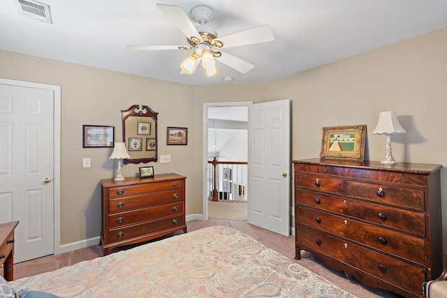 bedroom featuring baseboards, visible vents, and light colored carpet