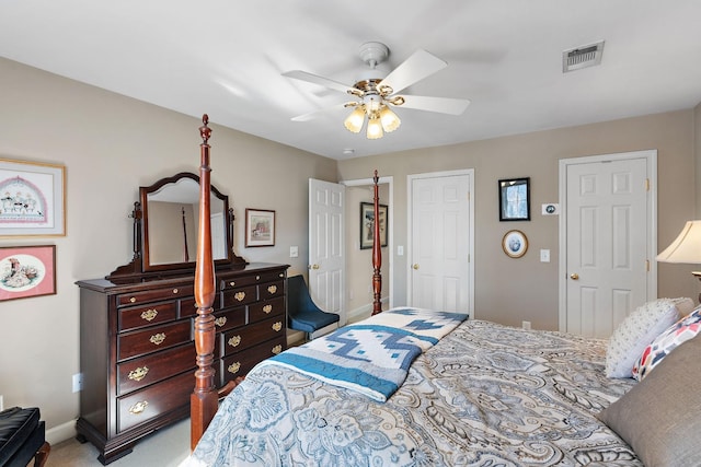 carpeted bedroom with ceiling fan, visible vents, and baseboards