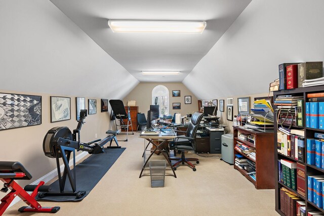 carpeted office space featuring lofted ceiling