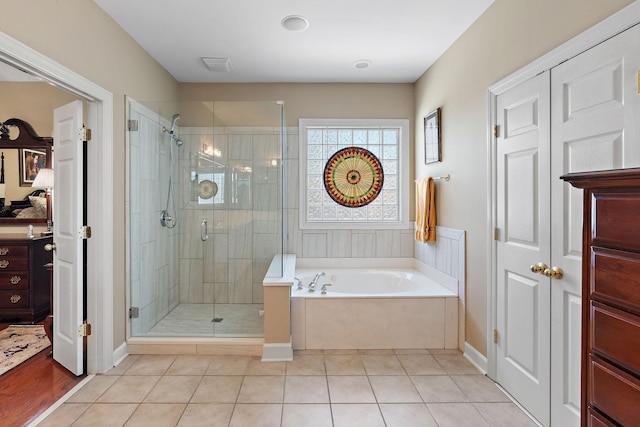 full bath with a shower stall, visible vents, a bath, and tile patterned floors