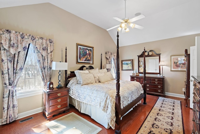 bedroom featuring dark wood-style floors, visible vents, vaulted ceiling, and baseboards