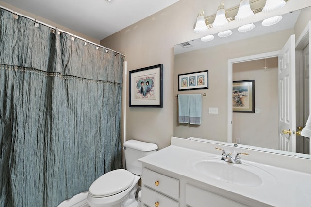 bathroom featuring visible vents, a shower with shower curtain, vanity, and toilet