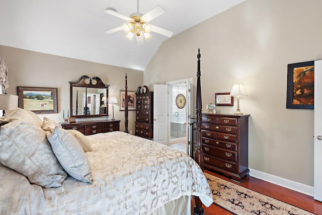 bedroom with baseboards, ensuite bath, ceiling fan, wood finished floors, and high vaulted ceiling