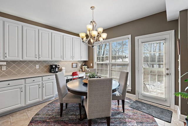 dining room featuring a chandelier and light tile patterned flooring