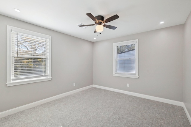 carpeted empty room featuring recessed lighting, a ceiling fan, and baseboards