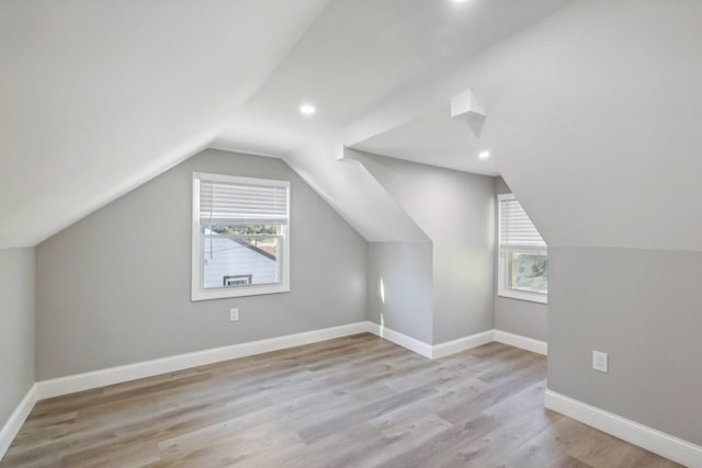 bonus room with vaulted ceiling, recessed lighting, wood finished floors, and baseboards