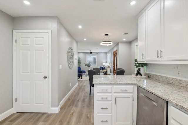 kitchen featuring light wood-type flooring, open floor plan, white cabinetry, and stainless steel dishwasher