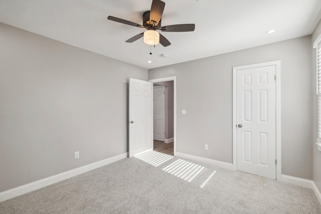 unfurnished bedroom featuring carpet floors, baseboards, a ceiling fan, and recessed lighting