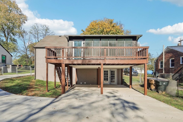 back of property featuring fence, a deck, and french doors