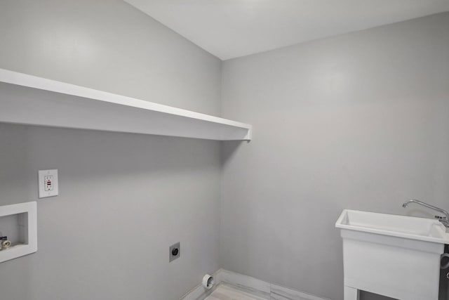 clothes washing area featuring laundry area, hookup for a washing machine, marble finish floor, electric dryer hookup, and a sink