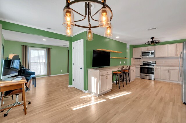 kitchen featuring appliances with stainless steel finishes, visible vents, crown molding, and light wood finished floors