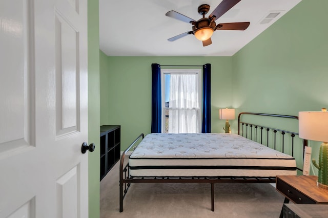 bedroom featuring a ceiling fan, carpet, visible vents, and radiator