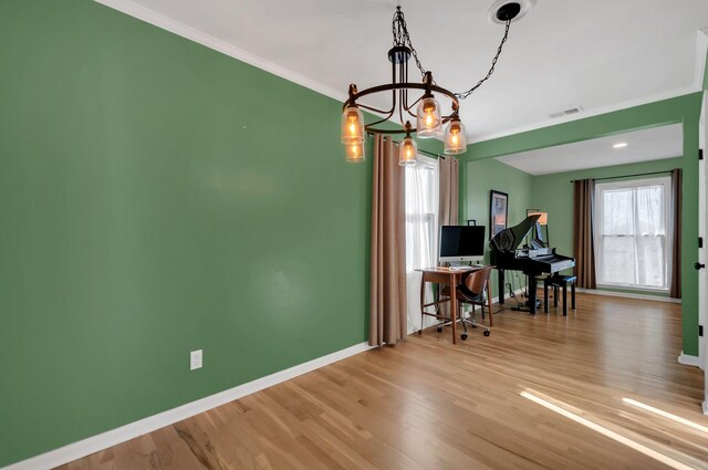 dining space with ornamental molding, visible vents, baseboards, and wood finished floors